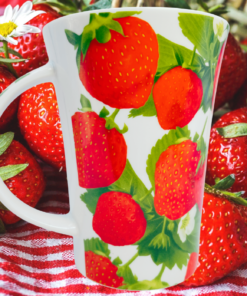 Strawberry Harvest Latte Mug styled with fresh strawberries and daisies