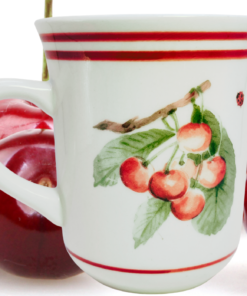Pfaltzgraff Delicious Fruit Garden Mug displayed with fresh cherries in a farmhouse kitchen setting