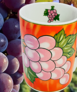 Grape Vineyard Red Coffee Mug displayed with vineyard grapes and harvest colors