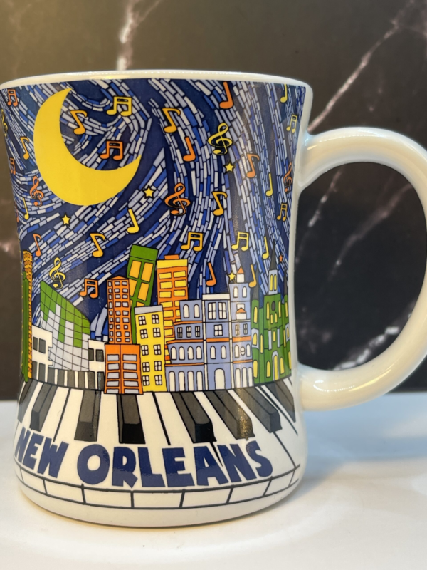 Start your mornings with a dash of jazz and Southern charm with this New Orleans Piano Music Skyline Mug! It’s the perfect #cupofmood to bring the energy and culture of the Crescent City right to your hands.Indeed, this 13-ounce white ceramic mug captures the soul of New Orleans through an eye-catching design. One that combines the city’s iconic skyline, vibrant music notes, and classic piano keys.