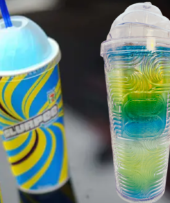 7-Eleven Slurpee Iridescent Swirl Tumbler displayed beside colorful Slurpee frozen drinks