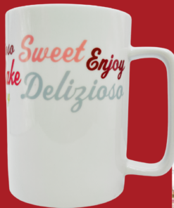 Cake Boss Icing & Quotes Porcelain Mug displayed in a cozy bakery kitchen beside pastries and coffee