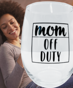 Mom Off Duty Stemless Wine Glass styled in a cozy home setting with a relaxed mom lounging on a couch