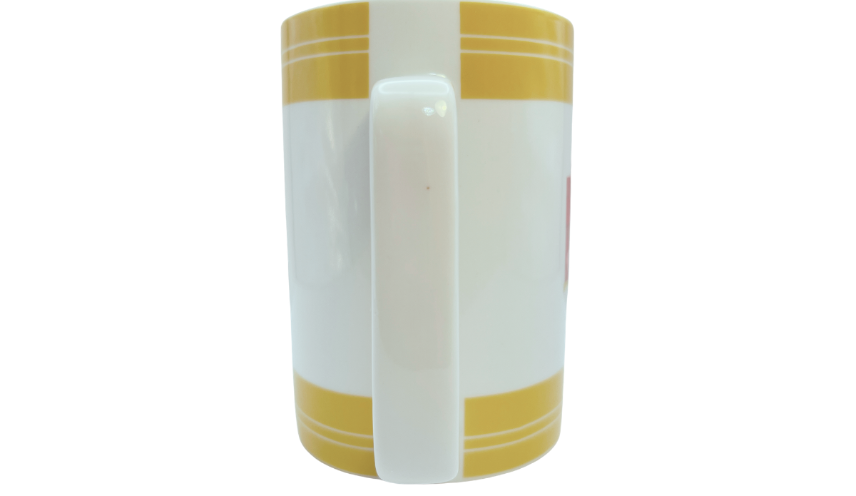 Handle view of Cake Boss Yellow Mini Cakes Porcelain Mug with oversized rectangular handle