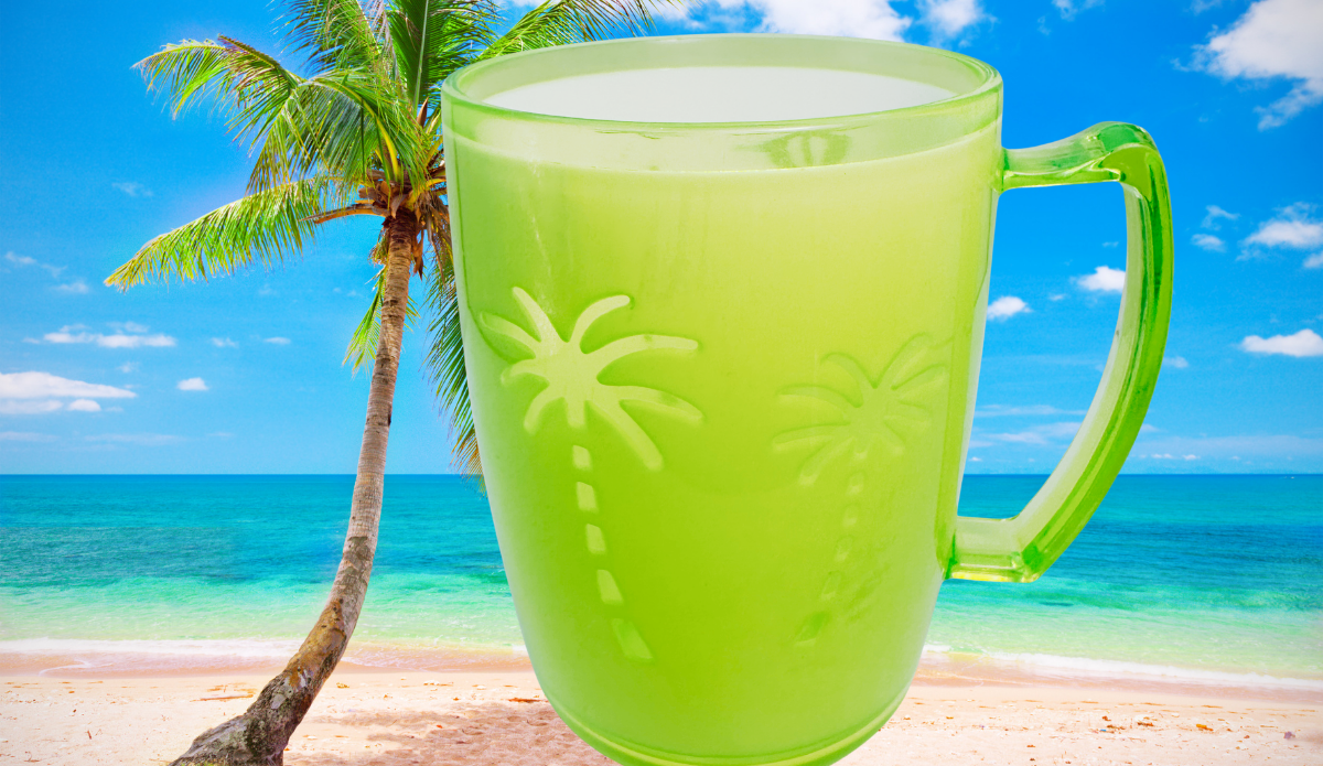 Neon green acrylic tumbler with embossed palm trees displayed on a tropical beach