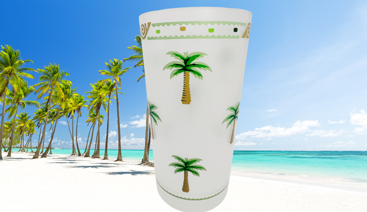 Vintage Palm Tree Acrylic Tumbler on a white sandy beach with turquoise water and swaying palm trees