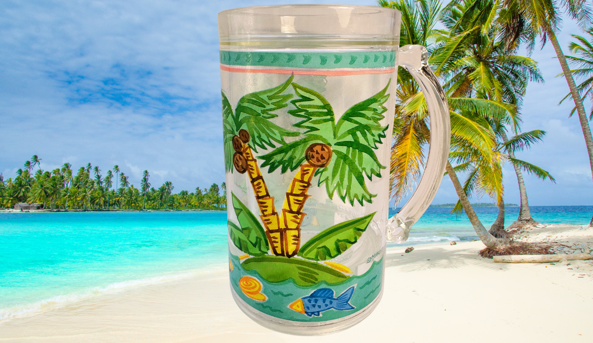Maret Tropical Palm Tree Freezer Mug displayed on a tropical beach