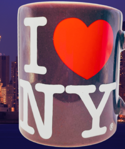 Purple I Love NY Mug displayed against the Statue of Liberty and illuminated New York City skyline at night