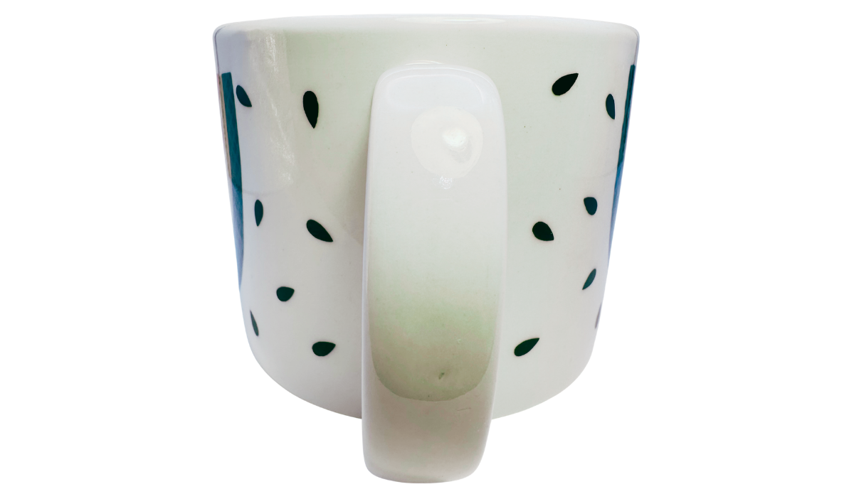 Vintage Tabletops Unlimited Fresh Watermelon Oversized Coffee Mug rear handle view with a centered white handle and scattered dark green seed accents.