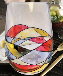 Hand Painted Mosaic Stemless Wine Glass displayed on an elegant dining table with place settings