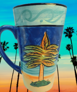 Certified International Palm Tree Latte Mug displayed outdoors at sunset with tall palm trees