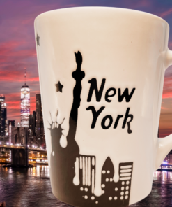 Signature Statue of Liberty New York Skyline Mug displayed against Lady Liberty and the Manhattan skyline at sunset