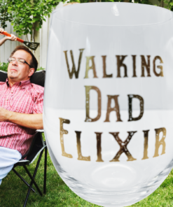 Walking Dad Elixir Stemless Wine Glass displayed during a humorous backyard family moment