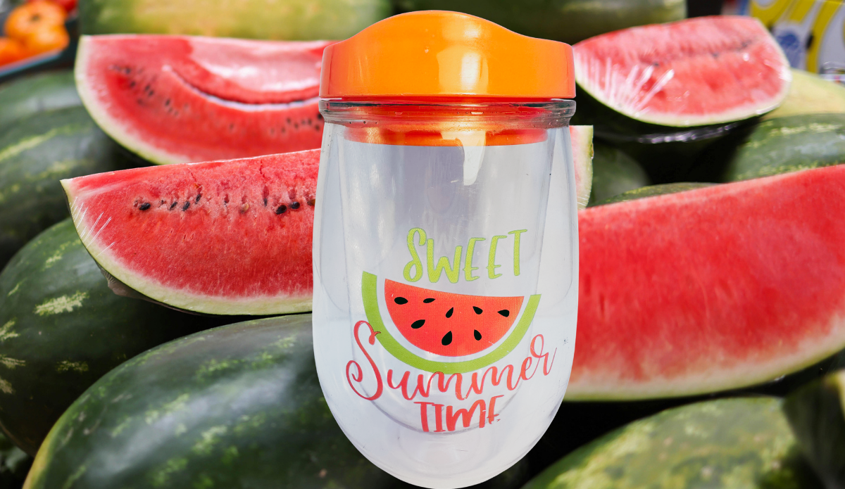 Sweet Summer Time Watermelon Acrylic Wine Tumbler displayed with fresh watermelon slices and whole watermelons in a bright summer setting.