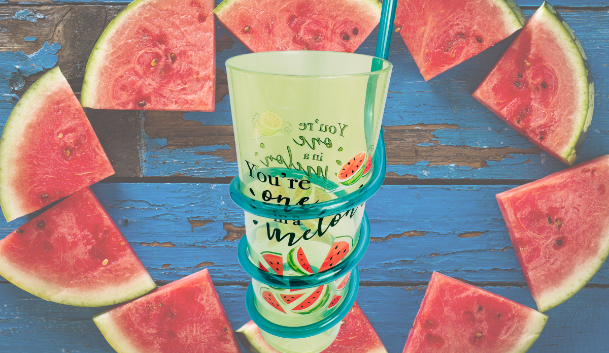 You’re One In A Melon Swirly Straw Acrylic Tumbler displayed among fresh watermelon wedges on a rustic blue wooden surface.