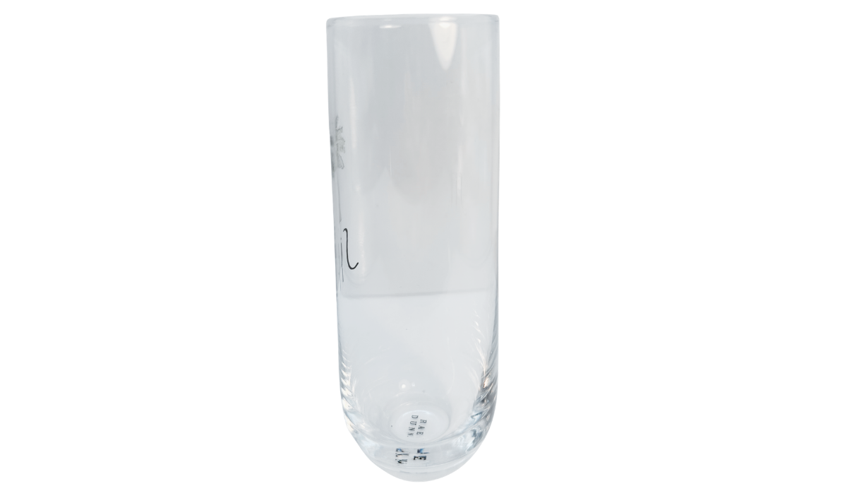 Reverse side of Rae Dunn SIP champagne flute showing artwork through gla