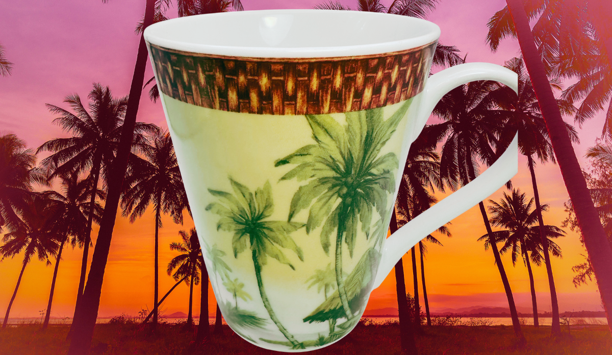 Godinger Tropical Palm Tree Porcelain Mug displayed against a tropical sunset with palm trees