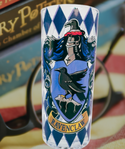 Harry Potter Ravenclaw House Crest Glass displayed with Harry Potter books, reading glasses, and a striped blanket