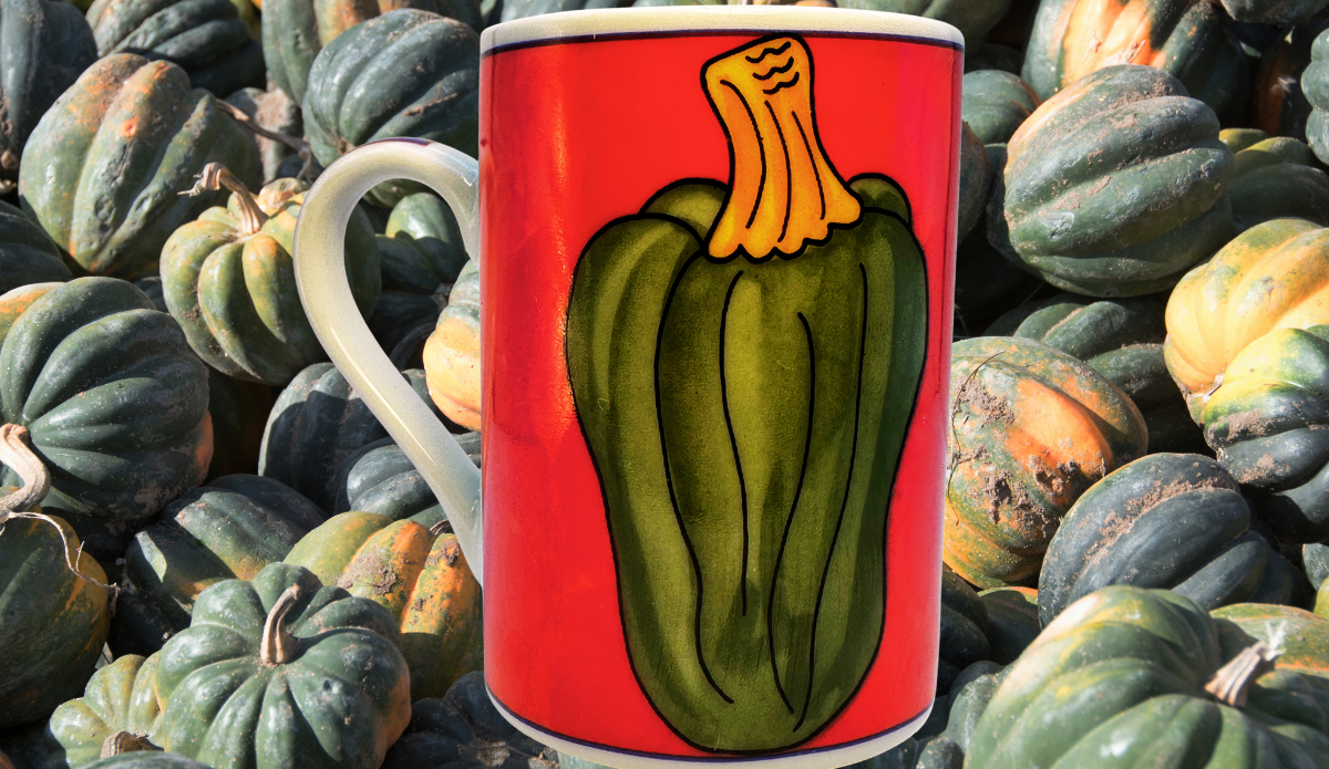 Vintage Acorn Squash Mug displayed among dark green acorn squashes with bold red artwork, golden stem, cobalt trim, and white handle.