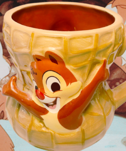 Disney Parks Chip and Dale 3D Peanut Mug displayed with Chip and Dale cartoon backdrop
