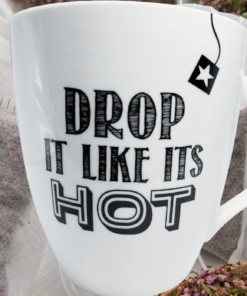 Drop It Like Its Hot Pfaltzgraff Mug displayed with tea bags and loose dried tea
