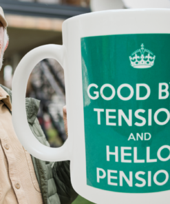Good Bye Tension Hello Pension Mug displayed with smiling retiree outdoors
