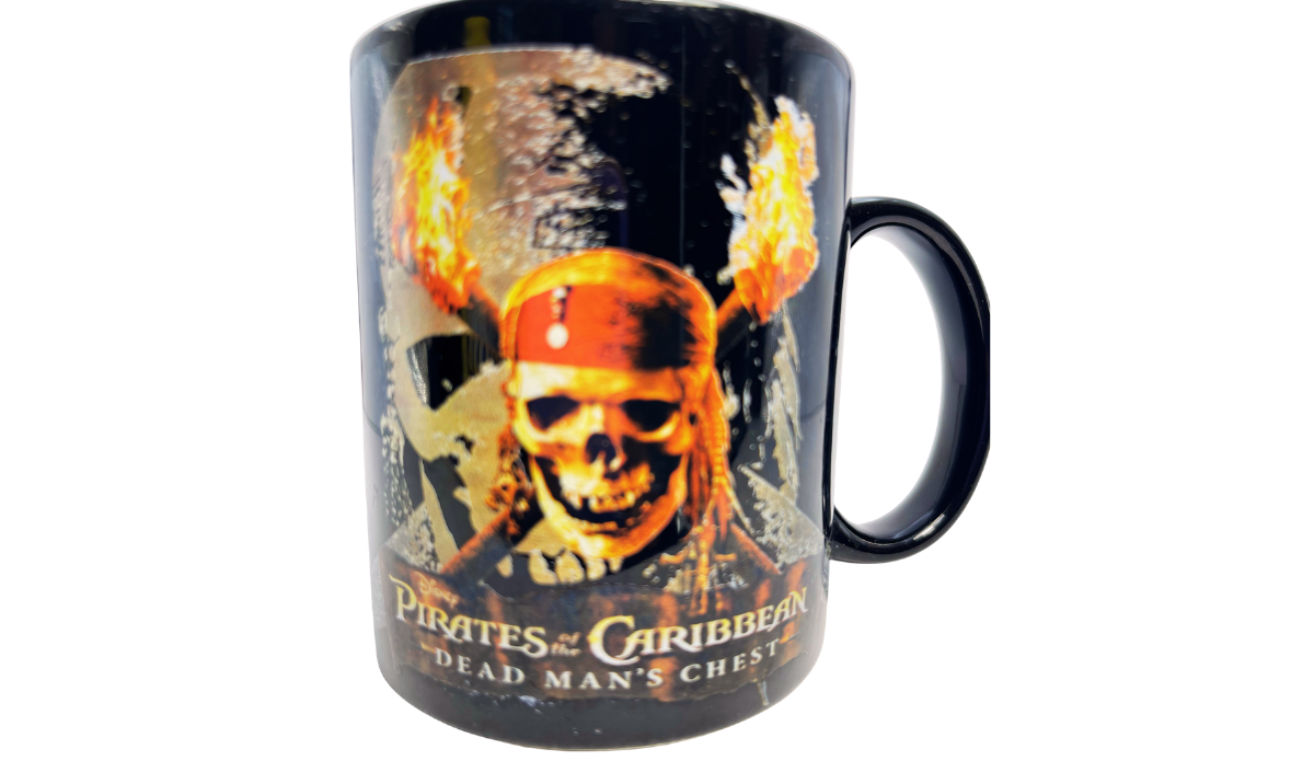 Disney Dead Mans Chest Mug with fiery pirate skull artwork on glossy black ceramic