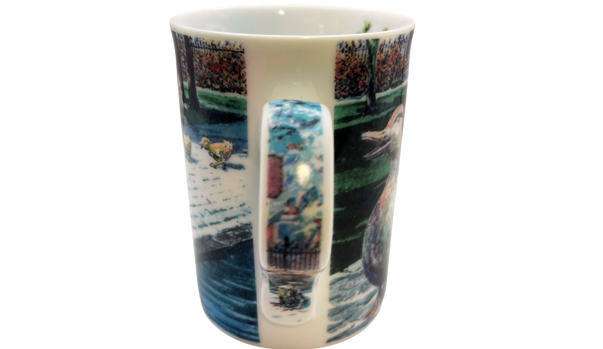 Ducklings II Mug handle view showing the slim white handle decorated with a continuation of the colorful landscape artwork.