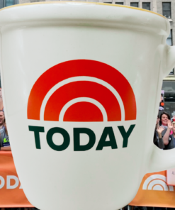 NBC TODAY Show mug displayed in front of the TODAY Plaza crowd in New York