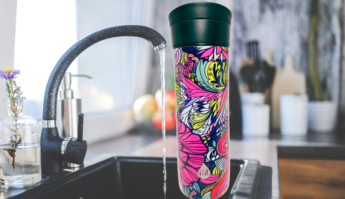 TAL Floral Water Bottle lifestyle scene beside kitchen sink with colorful floral artwork