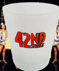 42nd Street Broadway frosted tumbler displayed before ensemble dancers onstage