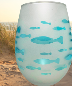 Aqua Fish Wine Glass displayed on beach dunes with ocean water and coastal grasses