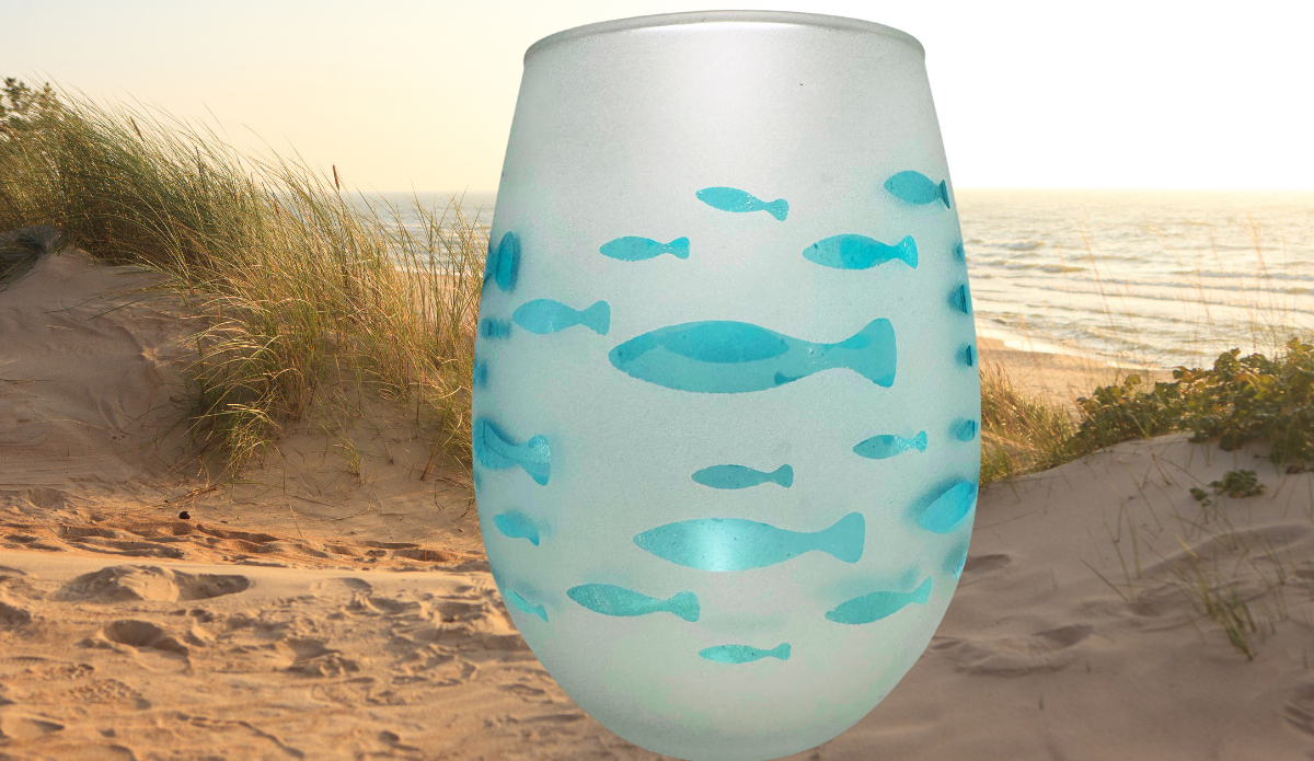 Aqua Fish Wine Glass displayed on beach dunes with ocean water and coastal grasses