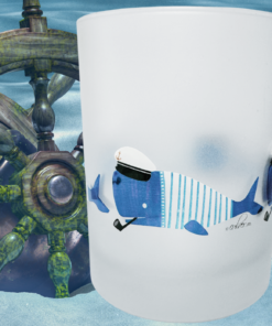 Sailor Whale Frosted Glass displayed beside weathered ship wheels in blue nautical setting