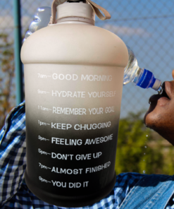 Black Ombre Motivational Water Bottle lifestyle scene with person hydrating outdoors beside motivational time markers