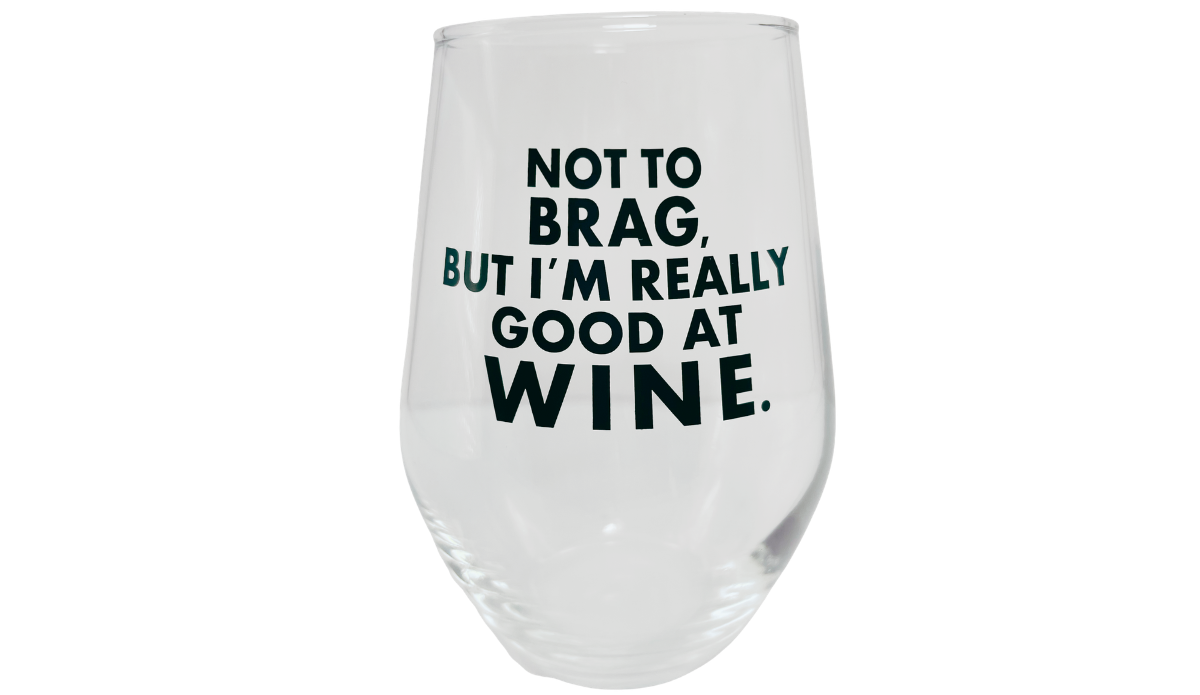 Really Good At Wine Glass with bold black Not To Brag lettering on clear stemless wine glass