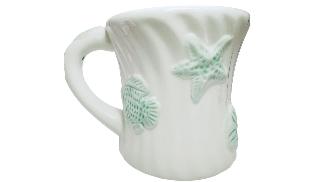Seafoam Green Seashell Mug with raised starfish fish and shell details on white ceramic