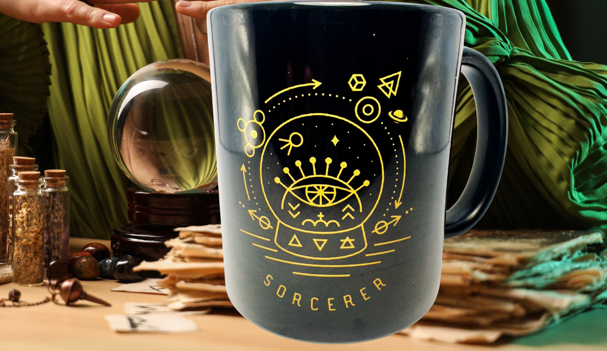 Sorcerer Crystal Ball Coffee Mug displayed with crystal ball and mystical fortune-telling accessories