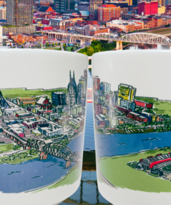 Nashville Tennessee Souvenir Mug lifestyle scene with two artwork views against an aerial Nashville city and river backdrop