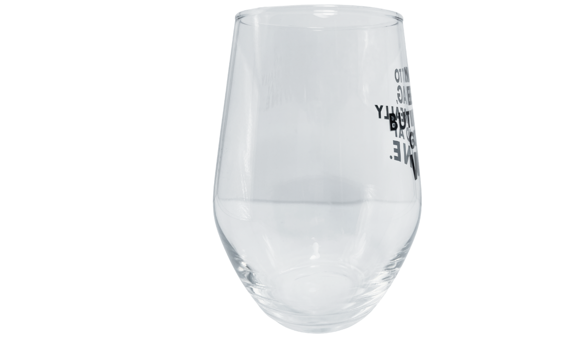 Really Good At Wine stemless glass with black wording shifting toward the right edge