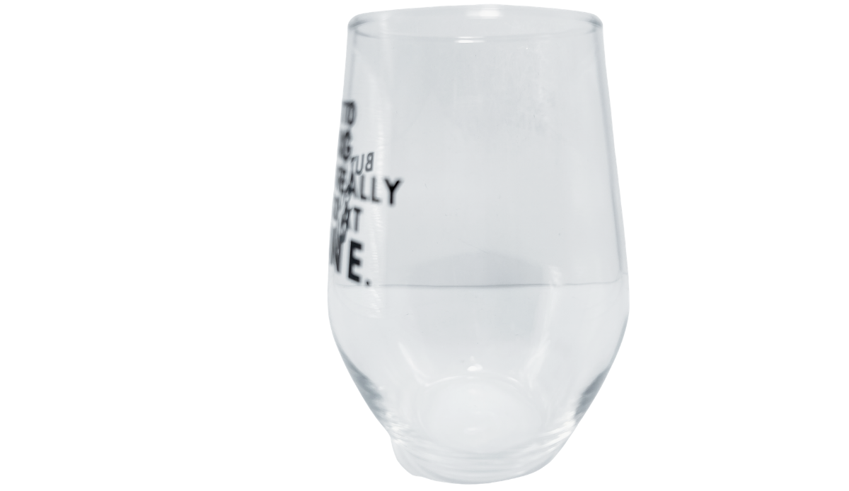 Clear Really Good At Wine stemless glass with black lettering visible along the left edge
