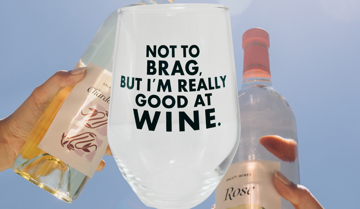 Really Good At Wine Glass displayed between white and rosé wine bottles against blue sky