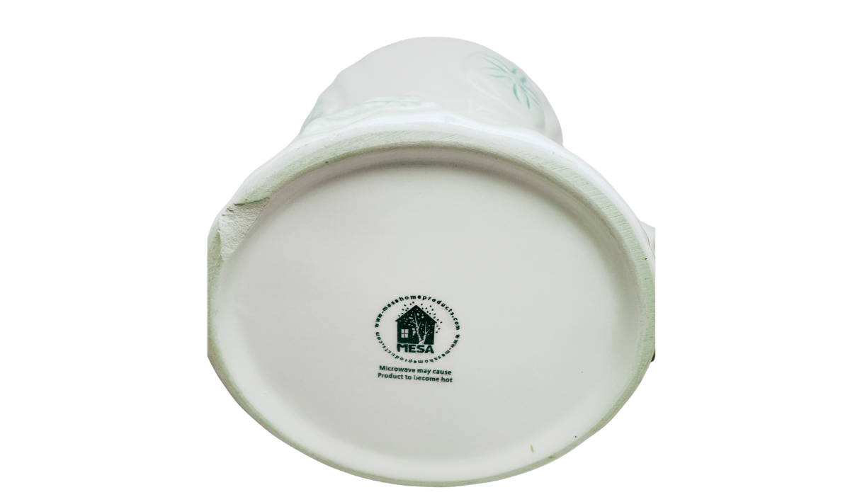 Bottom view of MESA Seafoam Green Seashell Mug with brand mark and microwave heat caution