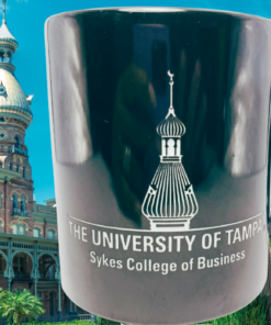 University of Tampa Mug displayed with historic campus architecture, palm trees, and blue sky in Tampa Florida