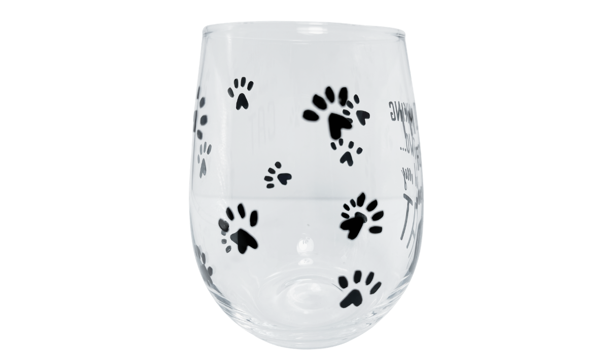 Cat stemless wine glass middle view with black paw prints wrapping around the clear glass