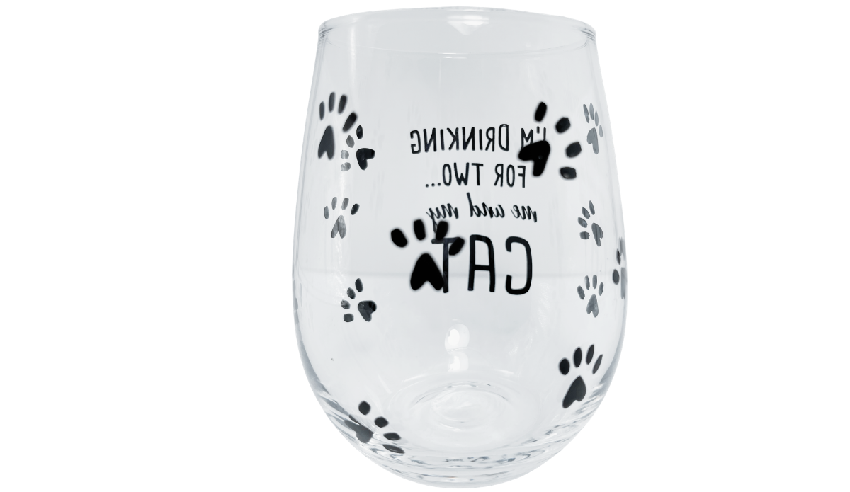 Back view of I'm Drinking for Two Cat Wine Glass with reversed wording and black paw prints visible through glass
