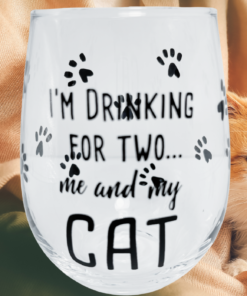 I'm Drinking for Two Cat Wine Glass displayed beside an orange and white cat in a cozy setting