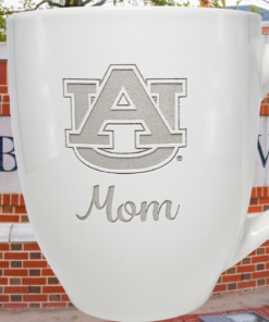 Auburn University Mom Mug displayed against an Auburn University campus entrance