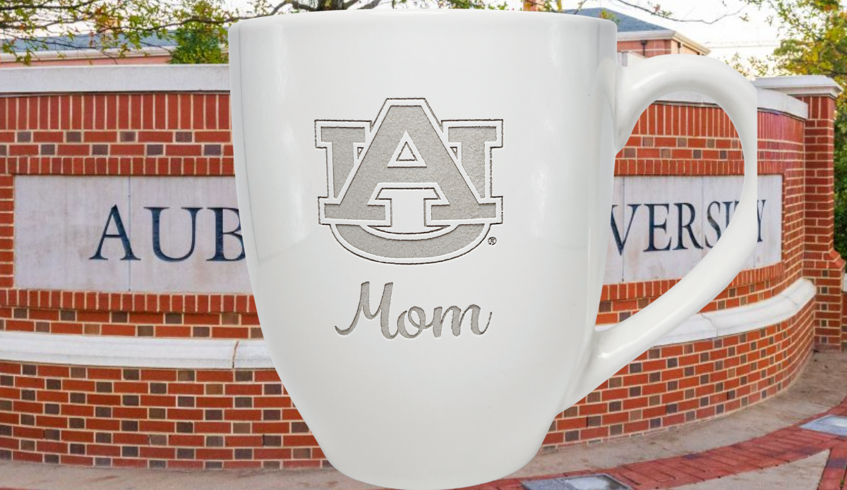 Auburn University Mom Mug displayed against an Auburn University campus entrance