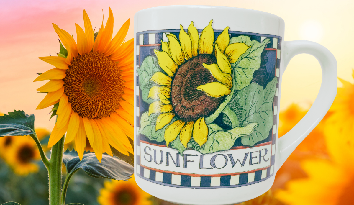 Susan Winget Sunflower Coffee Mug displayed beside a large sunflower with warm golden floral background